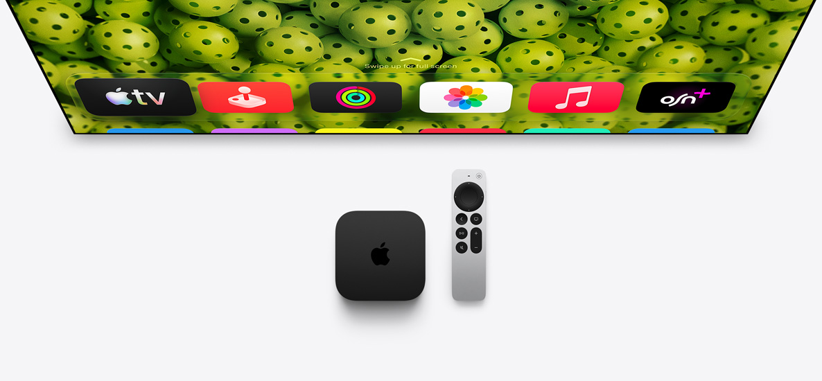 Apple TV 4K and Apple TV Remote below TV screen, screen shows Home Screen top row app icons over a green pickleballs background