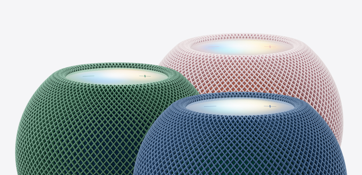 Three HomePod mini 2 speakers, green color, blue color, pink color, close-up of top exteriors, woven acoustic mesh fabric, illuminated touch surfaces