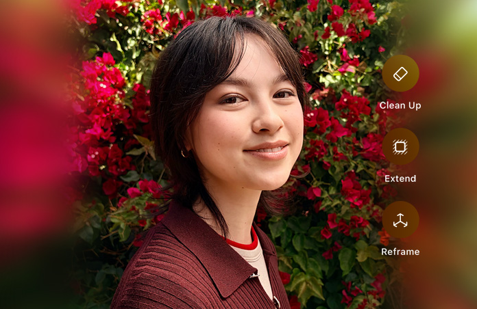 Photo d’une personne souriante aux cheveux bruns portant un chandail brun, entourée de fleurs rouges, démonstration de retouche photo avec l’IA à l’aide des options Nettoyer, Étendre et Recadrer superposées sur la photo